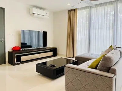 a living room with a couch and a tv at 3bdr Pool Villa Laguna Park-2 in Ban Phru Champa
