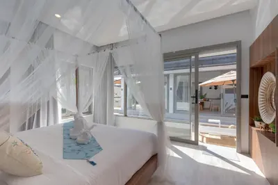 a bedroom with a bed with white mosquito nets at 3 Bedrooms Private Pool Villa near Laguna in Laguna Phuket