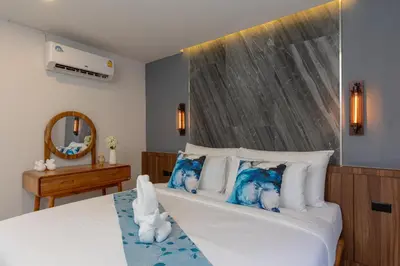 a bedroom with a bed with blue stuffed animals on the pillows at 3 Bedrooms Private Pool Villa near Laguna in Laguna Phuket