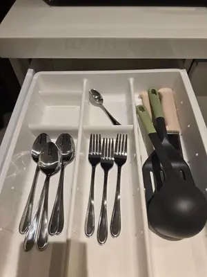 a tray with utensils in a kitchen sink at The beach front Condo in Ban Saiyuan (1)