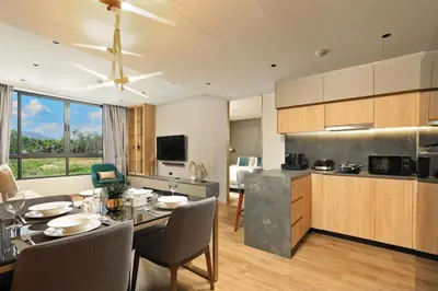 a kitchen and living room with a table and chairs at 2bdr Apartment with Bath near Bangtao Beach C512 in Laguna Phuket