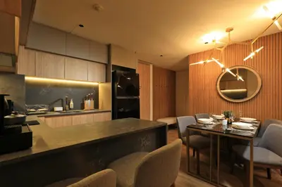 a kitchen and dining room with a table and chairs at 2bdr Apartment with Bath near Bangtao Beach C512 in Laguna Phuket