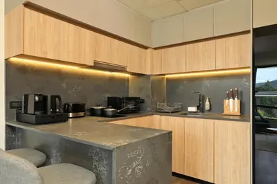 a kitchen with wooden cabinets and a counter top at 2bdr Apartment with Bath near Bangtao Beach C512 in Laguna Phuket