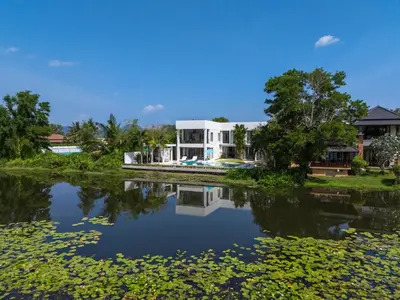a view of a house from the river at Lumière Villas Phuket - Golfside Retreat in Laguna in Laguna Phuket