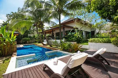 a backyard with a swimming pool and a house at Luxury 5 Bedroom Staffed Botanica Villas in Ban Phru Champa