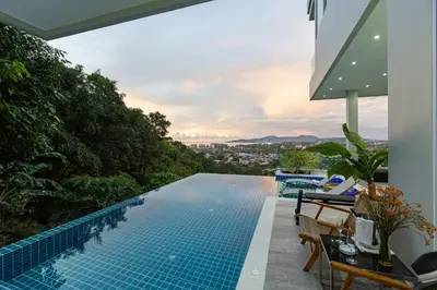 a swimming pool on the side of a house at Seaview three bedroom villa in Bangtao area in Ban Thalat Choeng Thale