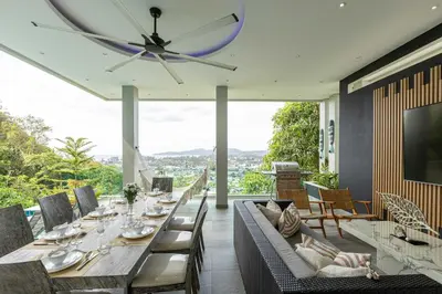 a dining room with a table and a ceiling fan at Seaview three bedroom villa in Bangtao area in Ban Thalat Choeng Thale