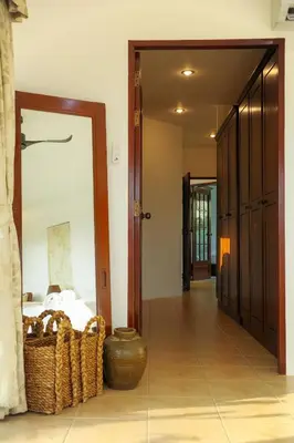 a room with a bed and a mirror and a door at Over the Moon villa in Patong Beach