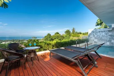 a patio with a table and chairs on a deck at The View Phuket F9 in Kata Beach
