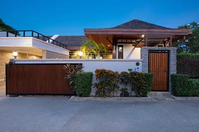 a house with a wooden gate and a fence at Tropical 2BR Pool Villa 3D12 in Gated Residence Rawai VIP Villas in Rawai Beach