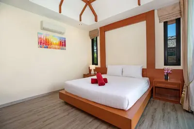 a bedroom with a white bed with a red bow on it at Tropical 2BR Pool Villa 3D12 in Gated Residence Rawai VIP Villas in Rawai Beach