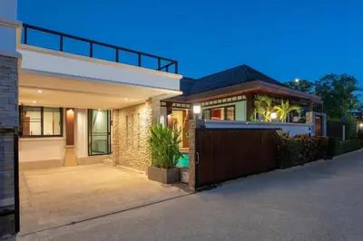 a house with a fence in front of it at Tropical 2BR Pool Villa 3D12 in Gated Residence Rawai VIP Villas in Rawai Beach