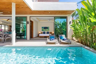 an indoor swimming pool in a villa with a patio at Modern Thai-Balinese 2-Storey Pool Villa Kael in Ka Villas Residence, 500m from Famous Rawai Beach Seafood Market in Rawai Beach