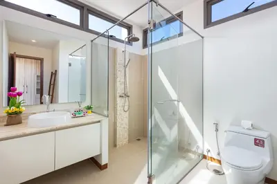 a bathroom with a glass shower and a toilet at Modern Thai-Balinese 2-Storey Pool Villa Kael in Ka Villas Residence, 500m from Famous Rawai Beach Seafood Market in Rawai Beach
