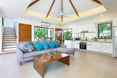 a living room with a couch and a table at Modern Thai-Balinese 2-Storey Pool Villa Kael in Ka Villas Residence, 500m from Famous Rawai Beach Seafood Market in Rawai Beach