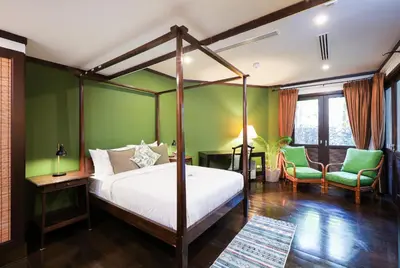 a bedroom with a canopy bed and green walls at Katamanda villa Eden Large Villa near Kata Beach in Kata Beach