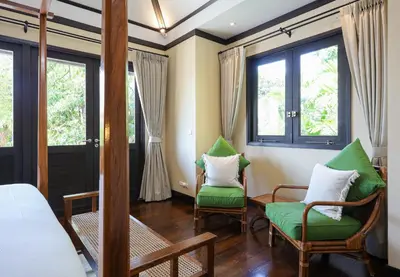 a bedroom with two chairs and a bed and windows at Katamanda villa Eden Large Villa near Kata Beach in Kata Beach