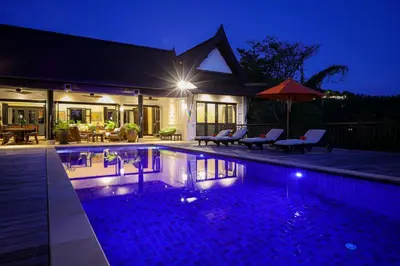a swimming pool in front of a house at night at Katamanda villa Eden Large Villa near Kata Beach in Kata Beach
