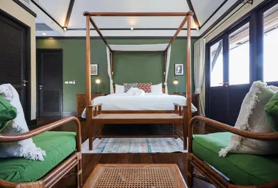 a bedroom with a canopy bed and two chairs at Katamanda villa Eden Large Villa near Kata Beach in Kata Beach