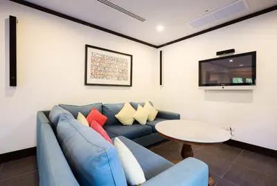a living room with a blue couch and a table at Katamanda villa Eden Large Villa near Kata Beach in Kata Beach