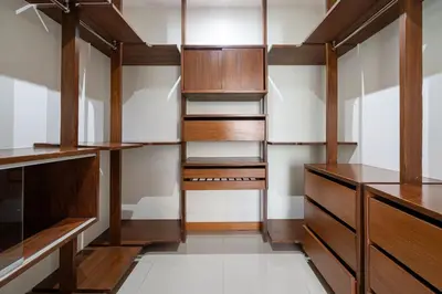 a walk in closet with wooden cabinets and shelves at Pool Villa Martin 3BR, Rawai in Rawai Beach