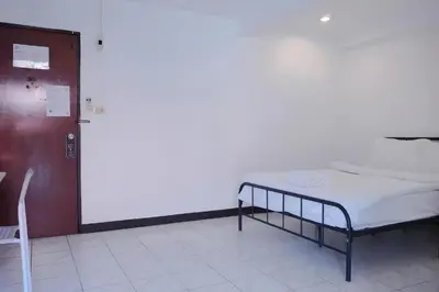 a hospital room with a bed and a chair at XX GO INN Phuket Patong Beach in Patong Beach