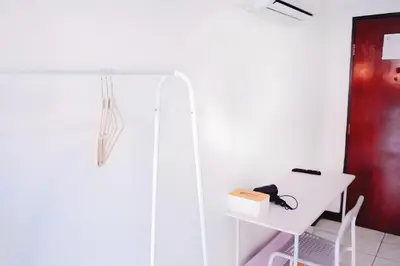 a bathroom with a shower and a white table at XX GO INN Phuket Patong Beach in Patong Beach