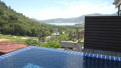 a swimming pool on the side of a house at Villa Loma & Patong 6 chambres in Patong Beach