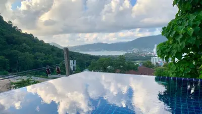 a swimming pool with a view of a mountain at Villa Loma & Patong 6 chambres in Patong Beach