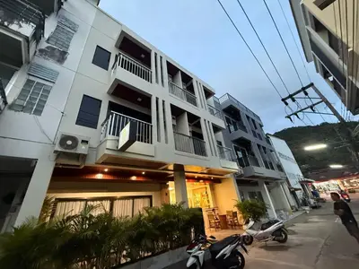 a motorcycle parked in front of a building at Sumaka Hotel Karon in Kata Beach