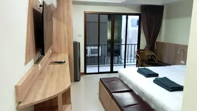 a hotel room with a bed and a balcony at Sumaka Hotel Karon in Kata Beach