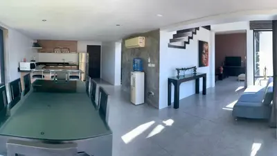 a large kitchen and living room with a table in it at Villa Loma & Patong 7 chambres in Patong Beach