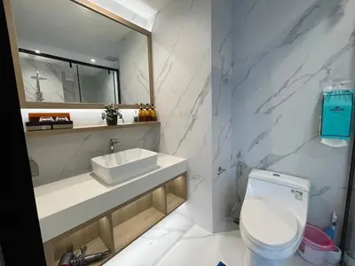 a white bathroom with a sink and a toilet at Laya Residence Memoory Layan in Ban Na Bon