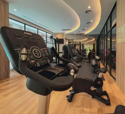 a gym with a row of treadmills and ellipticals at Laya Residence Memoory Layan in Ban Na Bon