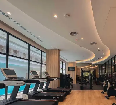 a gym with treadmills and ellipticals in a building at Laya Residence Memoory Layan in Ban Na Bon