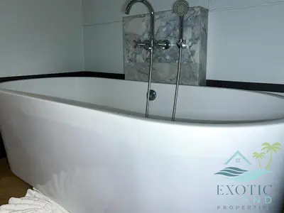 a white bath tub sitting in a bathroom at Stylish 3BR Private Pool Villa Bangtao Beach in Ban Pak Lak