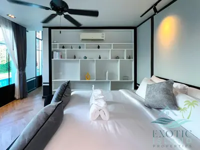 a bedroom with a bed with a stuffed animal on it at Stylish 3BR Private Pool Villa Bangtao Beach in Ban Pak Lak