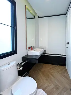 a bathroom with a white toilet and a sink at Stylish 3BR Private Pool Villa Bangtao Beach in Ban Pak Lak