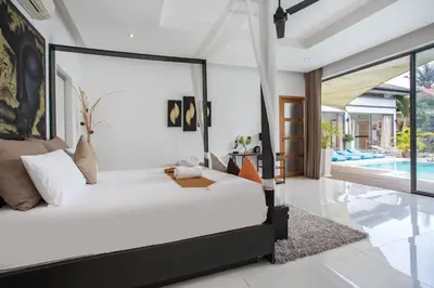 a bedroom with a bed and a swimming pool at Luxury 4BR Villa Virginie, Salt Pool, Rawai in Rawai Beach