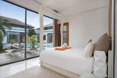 a bedroom with a white bed and a balcony at Luxury 4BR Villa Virginie, Salt Pool, Rawai in Rawai Beach