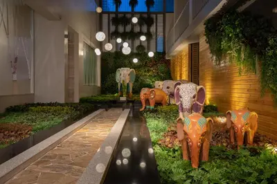 a lobby with statues of elephants on the ground at Ramada by Wyndham Phuket Deevana in Patong Beach