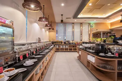 a restaurant kitchen with dishes on the counters at Ramada by Wyndham Phuket Deevana in Patong Beach