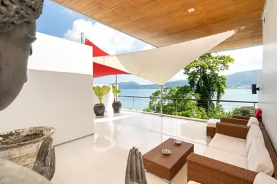 a living room with a view of the water at Atika Villa 7 ocean view pool villa in Patong Beach