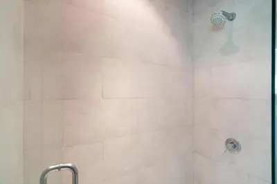 a bathroom with a shower with a shower head at Atika Villa 7 ocean view pool villa in Patong Beach