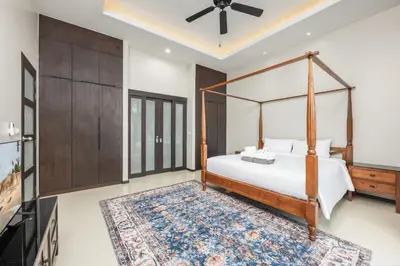 a bedroom with a canopy bed and a rug at Villa Neya 2BR Private Pool Close to Naiharn Beach in Rawai Beach