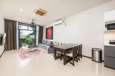 a living room with a table and a couch at Villa Neya 2BR Private Pool Close to Naiharn Beach in Rawai Beach
