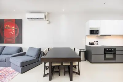 a living room with a table and a couch and a kitchen at Villa Neya 2BR Private Pool Close to Naiharn Beach in Rawai Beach