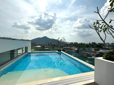 a swimming pool on the roof of a building at New 2br apartment -stylish Fantasea Kamala Condo in Kamala Beach