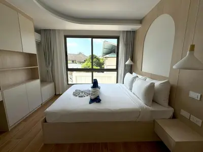 a bedroom with a large bed with a window at New 2br apartment -stylish Fantasea Kamala Condo in Kamala Beach