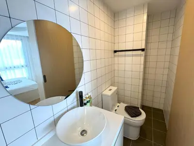 a bathroom with a sink and a toilet and a mirror at New 2br apartment -stylish Fantasea Kamala Condo in Kamala Beach